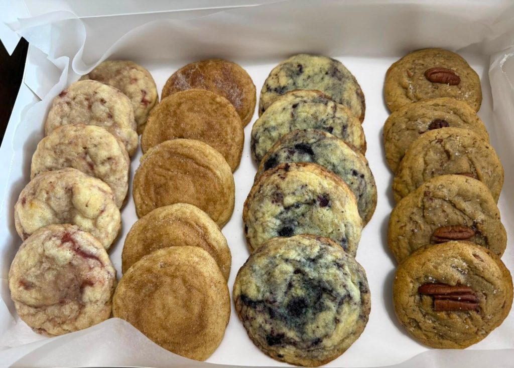 A tray of homemade cookies including snickerdoodle, butter pecan and lemon blueberry