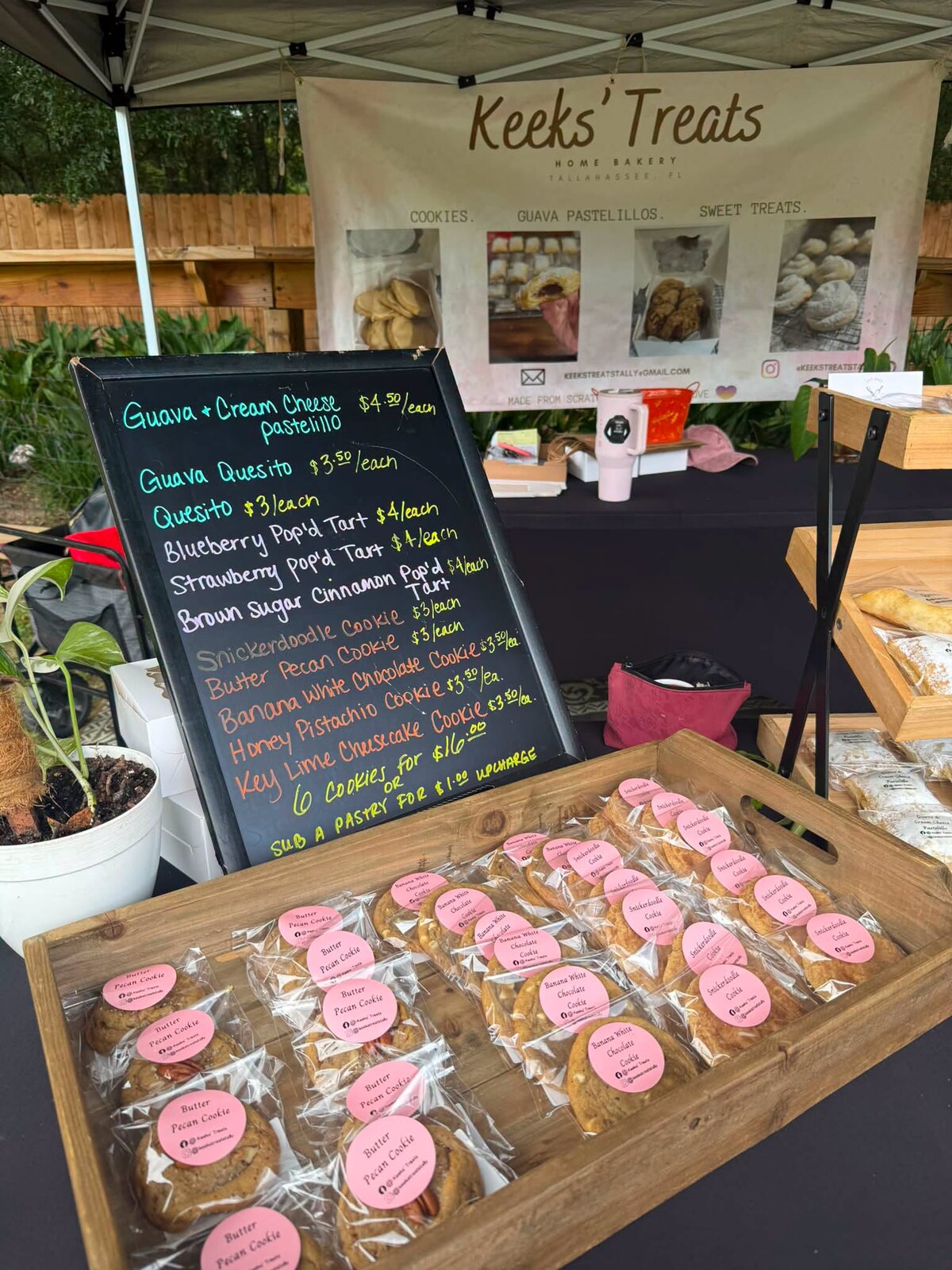 The Keeks’ Treats stall at Feather Oaks Farmers Market with a chalkboard menu and a tray of pastries